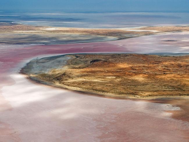 Rare pinkish water in flooded Lake Eyre. Picture: Alamy