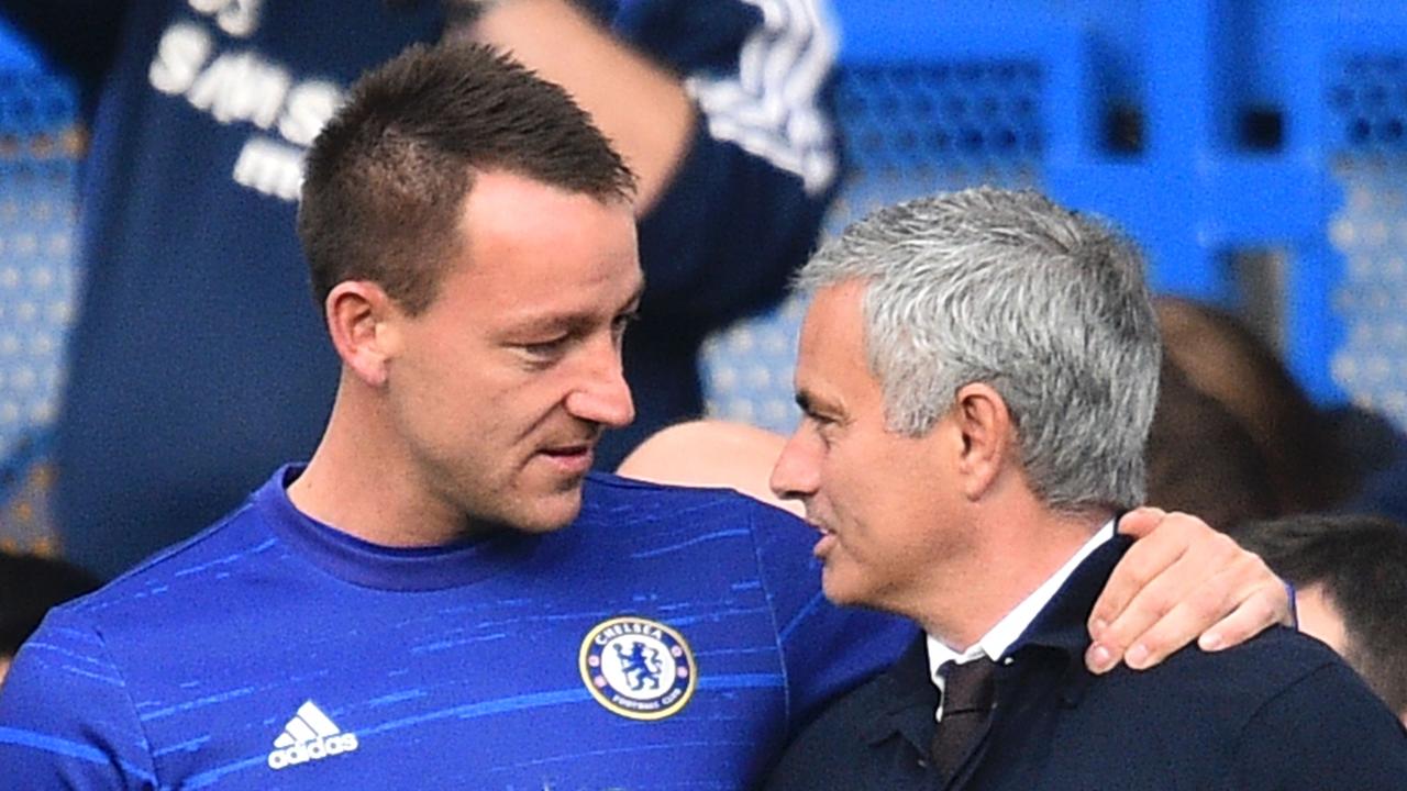 Manchester United's Portuguese manager Jose Mourinho (R) speaks to Chelsea's English defender John Terry