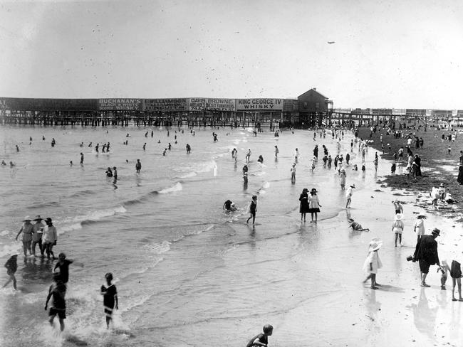 Holiday-makers at Glenelg beach in 1923, with the jetty in the background. Source: State Library of SA