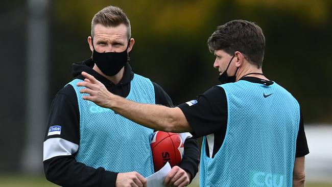 MELBOURNE, AUSTRALIA - JUNE 01: Magpies head coach Nathan Buckley talks to assistant coach Robert Harvey during a Collingwood Magpies AFL training session at Holden Centre on June 01, 2021 in Melbourne, Australia. (Photo by Quinn Rooney/Getty Images)