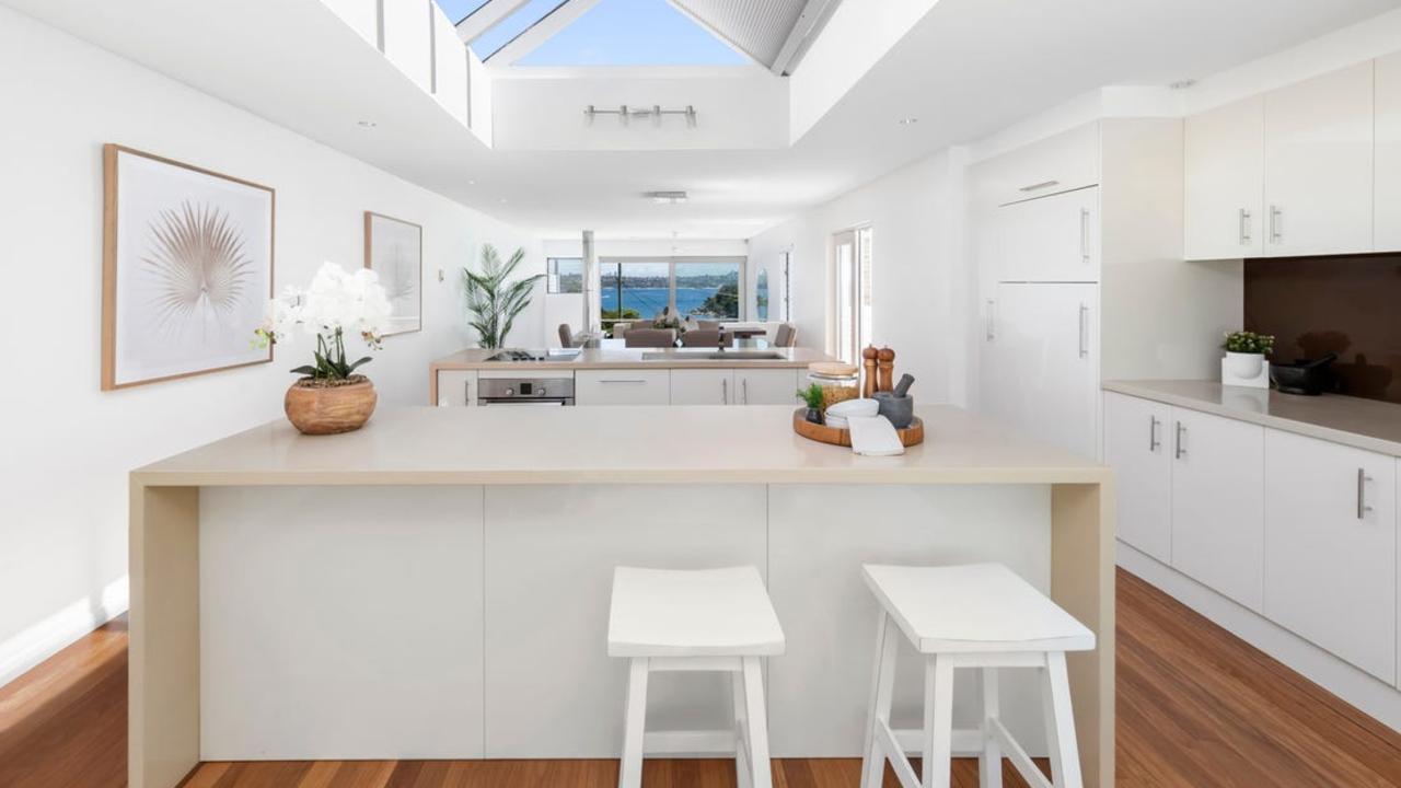 Entertainers’ kitchen with two Caesarstone island benches plus dishwasher. Picture: REA