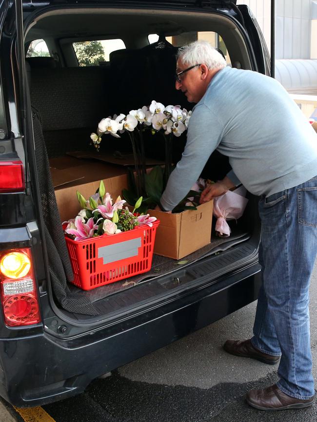 Flowers are delivered to the North Bondi home. Picture: Richard Dobson