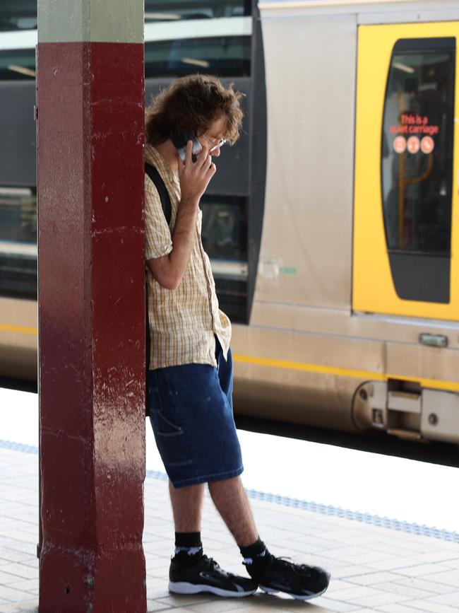 A delayed passenger at Central Station on Wednesday. Picture: Ted Lamb