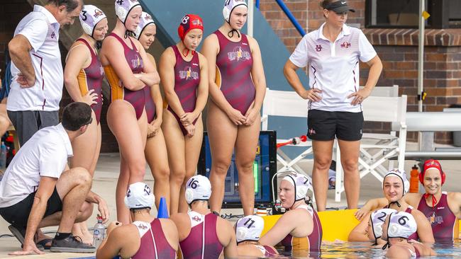 Andrews, arms folded, and her team mates listen to Queensland Thunder coach Benn Lees against UWA Torpedoes earlier this month. (AAP Image/Richard Walker)