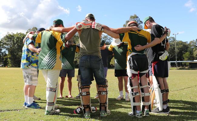 Members of the Yandina Cricket Club hold a minute’s silence.