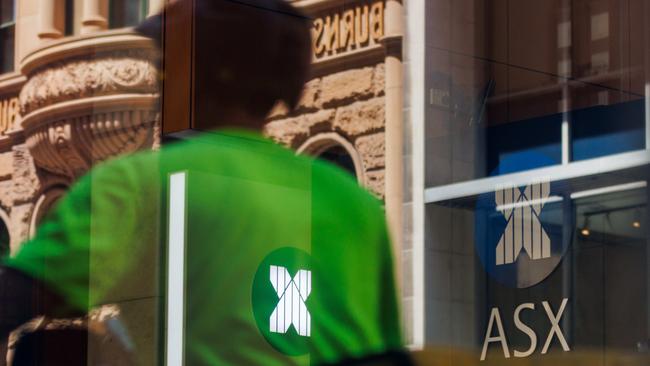 SYDNEY, AUSTRALIA - NewsWire Photos, October 29 2024. GENERIC. Stocks. Finance. Economy. A food delivery rider passes the Australian Stock Exchange, ASX, on Bridge Street. Picture: NewsWire / Max Mason-Hubers