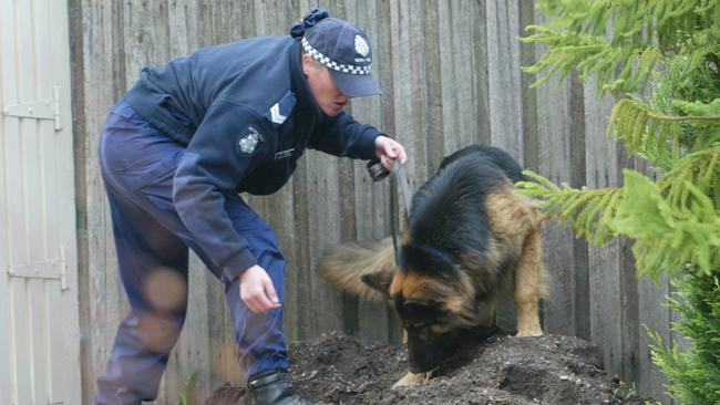 Forensic police and detectives search the Mornington home of John Sharpe.