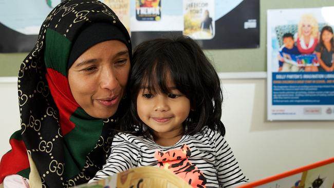 Shafa is read to in Davoren Park by her mother. Picture: Supplied