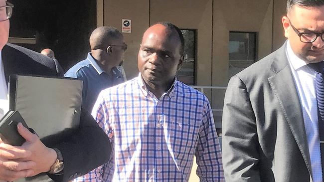 John Mugambi Mwamba walks into Townsville Magistrates Court facing fraud charges as the deputy chief executive officer and director of financial services for Palm Island Aboriginal Shire Council. Photo: Jacob Miley