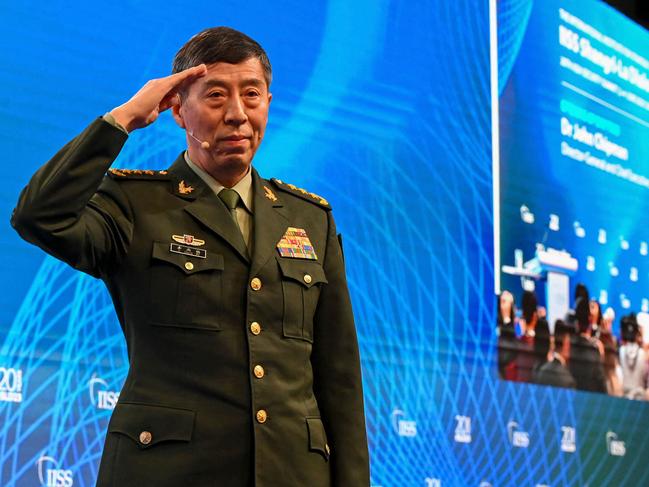 China's Minister of National Defence Li Shangfu salutes the audience before delivering a speech during the 20th Shangri-La Dialogue summit in Singapore on June 4, 2023. (Photo by Roslan RAHMAN / AFP)