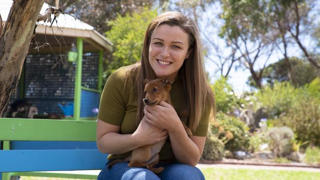 Nicole Olsen with puppy Angel, who she rescued from a roadside bin in November. Photo: RSPCA