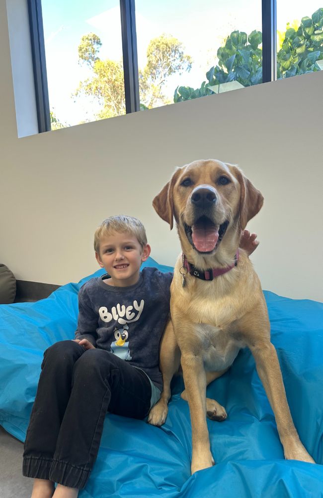 RJ with his therapy dog Kora who his mum said helped him sleep better at night. Picture: Supplied