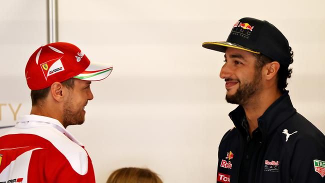 Sebastian Vettel talks with Daniel Ricciardo.
