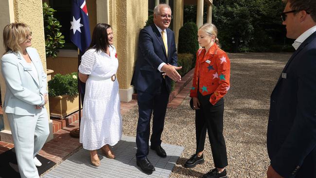 Scott Morrison outstretches his hand to shake that of Grace Tame’s fiance, Max Heerey. Picture: NCA NewsWire / Gary Ramage