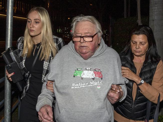 Former swim coach Dick Caine leaving Bankstown police station with wife Jenny and lawyer Sophie Newham after receiving bail in 2022. Picture: Liam Mendes