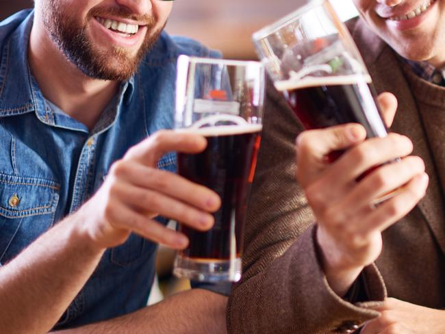 From istock, two friends hanging out together drinking dark beers. Source: Supplied