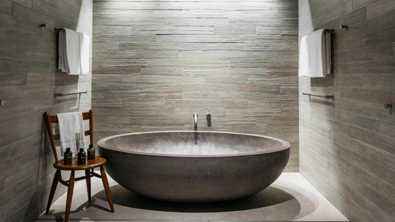 The bathtub easily accommodates two adults — it’s like a small pool in your room!