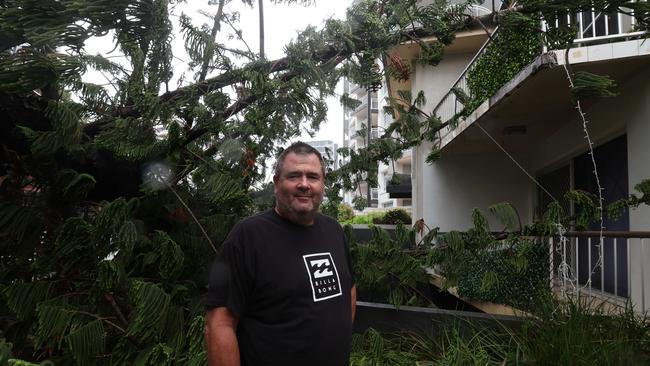 Gold Coast battered by Cyclone Alfred, as it made land.  Old Burleigh Rd resident Michael Spurge with the Norfolk Pine on his unit...  Picture Glenn Hampson