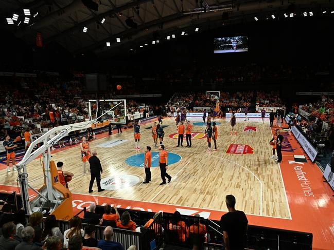 CAIRNS, AUSTRALIA - DECEMBER 07: Players and officials mingle on court during the extended shot clock outage during the round 10 NBL match between Cairns Taipans and Sydney Kings at Cairns Convention Centre, on December 07, 2023, in Cairns, Australia. (Photo by Emily Barker/Getty Images)