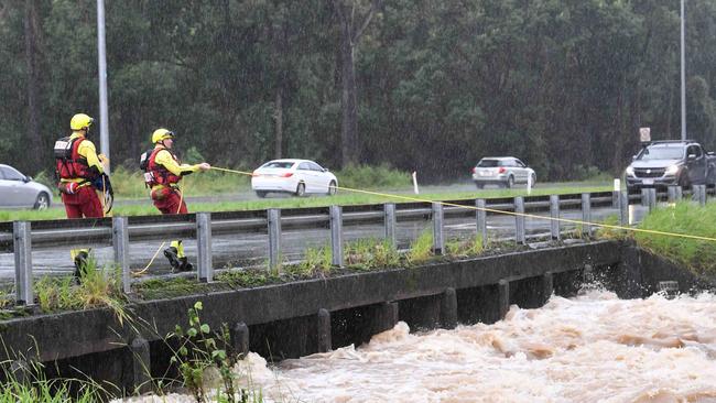 CYCLONE AFLRED: Swiftwater crews swung into action at Woombye, near Nambour Connection Road, after a submerged car was found in the carpark. Picture: Patrick Woods.