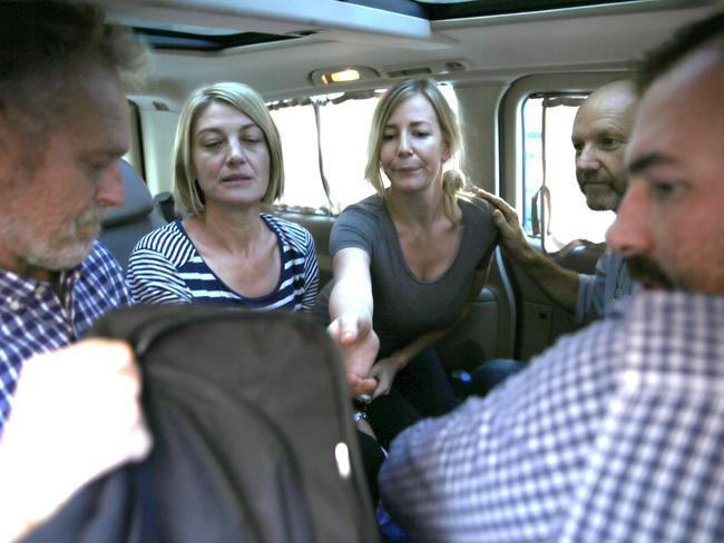 Tara Brown, second left, and Sally Faulkner, centre, and the 60 Minutes crew on the way to the airport.  Picture: AP.