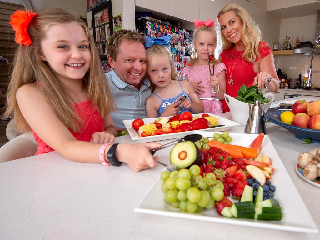 Scott and Fiona Annett with their kids, Sophie, 8, and 6-year-old twins Tilly and Jessie with healthy produce. Picture: Jay Town