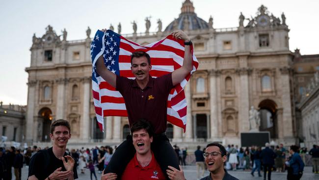 US citizens react after newly elected Pope Leo XIV. (Photo by Dimitar DILKOFF / AFP)