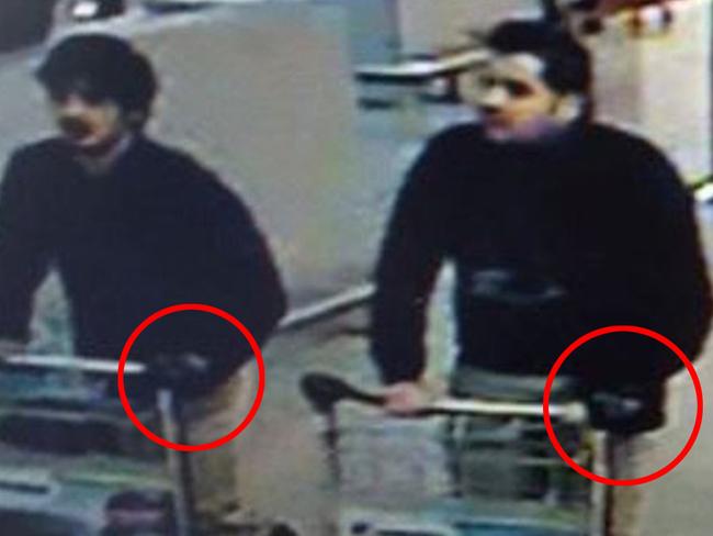 COMPOSITE (MAN ON RIGHT DRAWN CLOSER INTO IMAGE, GLOVES CIRCLED) In this image provided by the Belgian Federal Police in Brussels on Tuesday, March 22, 2016 of three men who are suspected of taking part in the attacks at Belgium's Zaventem Airport. The man at right is still being sought by the police and two others in the photo that the police issued were according to a the Belgian Prosecutors 'probably' suicide bombers. Bombs exploded at the Brussels airport and one of the city's metro stations Tuesday, killing and wounding scores of people, as a European capital was again locked down amid heightened security threats. (Belgian Federal Police via AP)