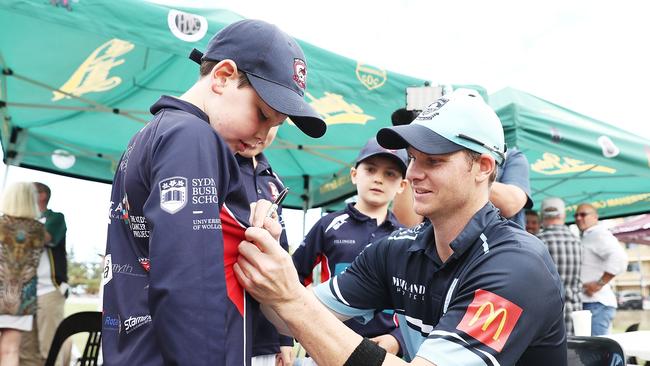 Steve Smith signs autographs for children during the clash between Randwick-Petersham and Sutherland. (Photo by Mark Metcalfe/Getty Images)