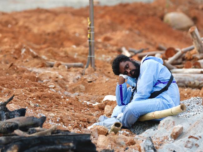 A man wearing PPE waits to perform the last rites of a deceased relative in a new crematorium in Bengaluru, India. Picture: Getty