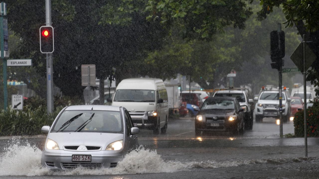 Cars drive down a flooded Spence St at the Reef Fleet Terminal . PICTURE: ANNA ROGERS