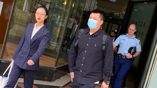 Shigang Wang pictured walking outside Downing Centre Court with his lawyer.