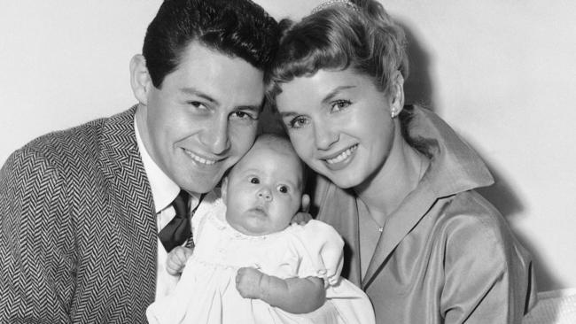 Eddie Fisher and Debbie Reynolds hold their baby daughter, Carrie Frances Fisher, in 1957.