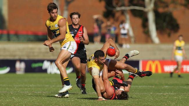 SANFL match between West Adelaide and Eagles at City Mazda Stadium. Eagles Jimmy Toumpas tangles with Wests Aaron Anderson. Picture: Dean Martin