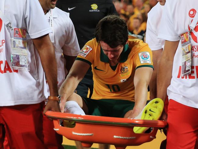 Australia's Robbie Kruse is carried from the pitch after being injured during the Asian Cup Final between Australia and Korea Republic at Stadium Australia, Homebush. Picture: Toby Zerna