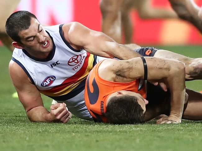 CANBERRA, AUSTRALIAN CAPITAL TERRITORY - AUGUST 11:  Josh Kelly of the Giants hits the pitch from a sling tackle from Taylor Walker of the Crows during the round 21 AFL match between the Greater Western Sydney Giants and the Adelaide Crows at UNSW Canberra Oval on August 11, 2018 in Canberra, Australia.  (Photo by Matt King/AFL Media/Getty Images)