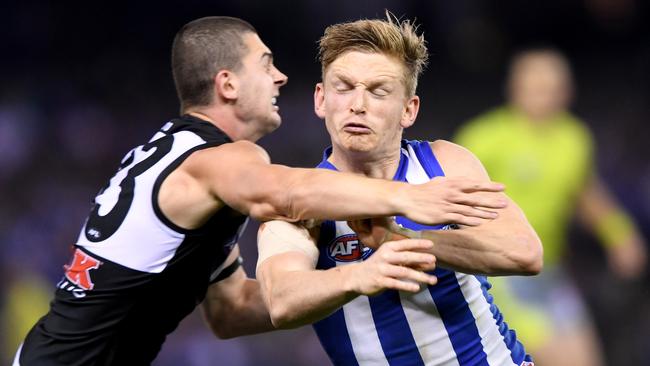 Darcy Byrne-Jones of the Power tackles Jack Ziebell of the Kangaroos. Picture: AAP Image/Joe Castro