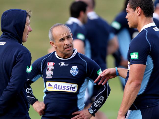 Timana Tahu discusses his injury with coach Craig Bellamy and team physiotherapist Tony Ayoub during a training session.