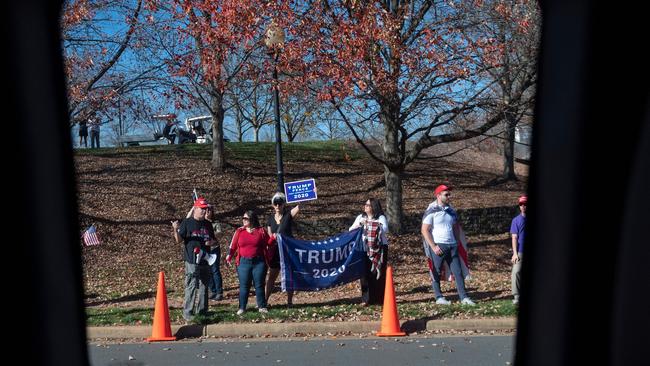 Supporters of US President Donald Trump stand outside the Trump International Golf Club in Sterling, Virginia on November 8, 2020 as Mr Trump plays golf again today. Picture: Andrew Caballero-Reynolds/AFP