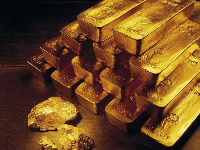 In this undated handout photo from Newmont Mining Corporation, gold nuggets and bars are shown. With the price of gold back in the mid-$500 range, the highest level since 1981, mining companies are pouring money into exploration around the world. (AP Photo/Newmont Mining)