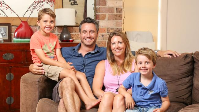 Owen and Katie Burns with their two boys Sam, 7, and Ollie, 5, in their Newcastle rental home. Picture: Ryan Osland