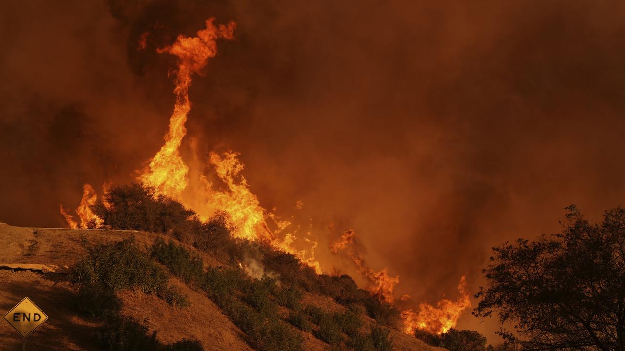 A firefighter battles the Palisades Fire in Mandeville Canyon Saturday, Jan. 11, 2025, in Los Angeles. (AP Photo/Jae C. Hong)