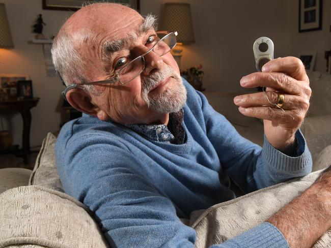 Dr John Rice did SA's first child cochlear implant, operated on 50 kids in his career - now he has had an implant at age 85. He pictured an original prototype of the cochlear implant at his McCracken home which he shares with his wife Jenny. Picture: Tricia Watkinson