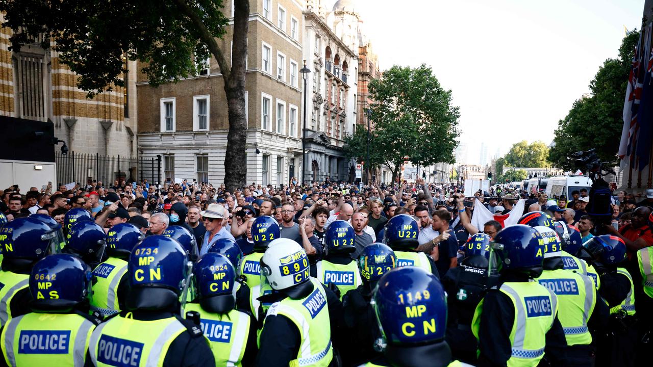 Police officers face protesters during the 'Enough is Enough' demonstration on Whitehall. Picture: AFP