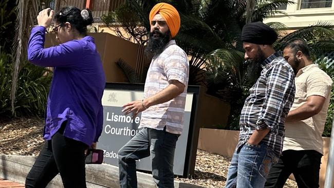 Lovepreet Singh (second from left) is fighting charges. He is pictured with supporters outside Lismore Courthouse.