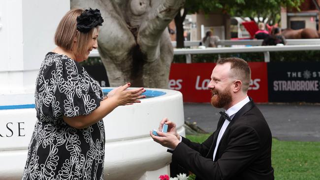 Stephen Butler proposes to Gemma Davidson at Derby Day at Eagle Farm Racecourse. Picture: Liam Kidston