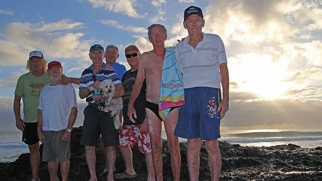 Mick Barry (holding the dog) with other swimmers. Photo: ABC