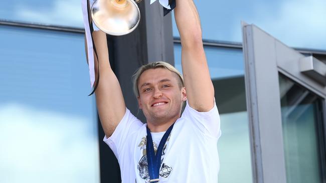 MELBOURNE, AUSTRALIA - OCTOBER 01: Darcy Moore the captain of the Magpies holds up the Premiership Cup during the Collingwood Magpies AFL Grand Final celebrations fan day at AIA Centre on October 01, 2023 in Melbourne, Australia. (Photo by Quinn Rooney/Getty Images)