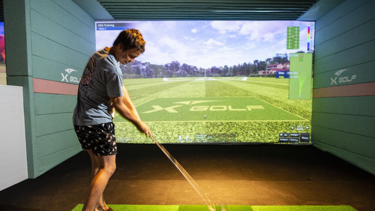 ON COURSE: Max Garvie tees off at X-Golf Toowoomba. Picture: Kevin Farmer