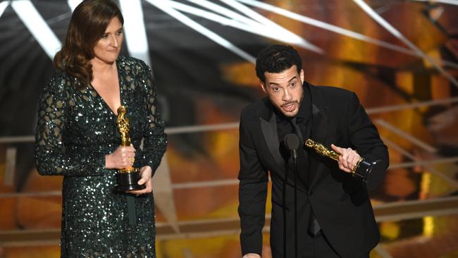 Ezra Edelman, right, and Caroline Waterlow accept the award for O.J.: Made in America. Picture: AP